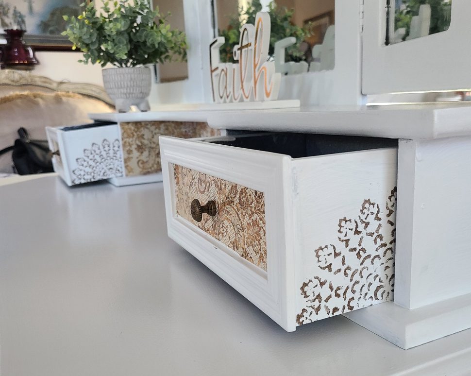 A white table with some drawers and plants