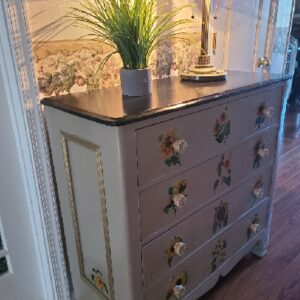 A dresser with some plants on top of it