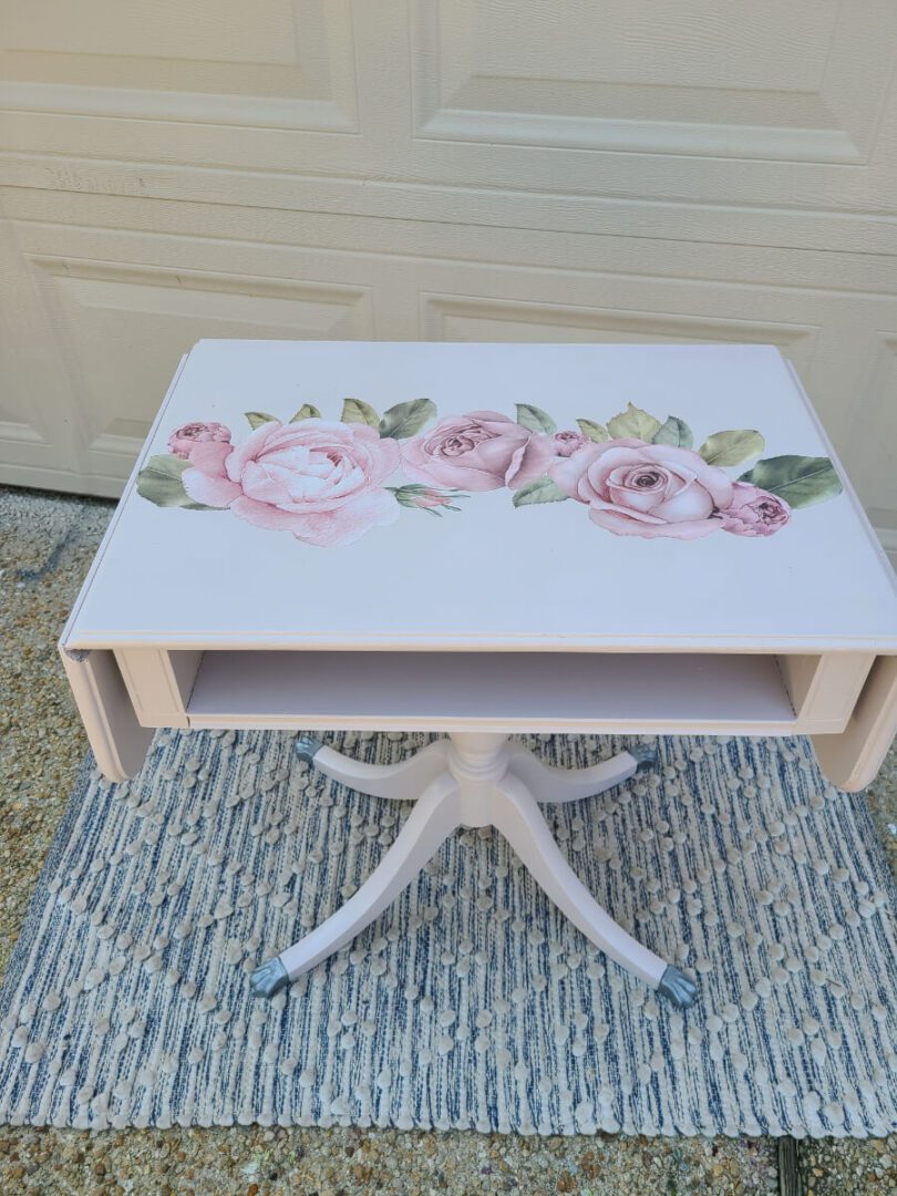 A table with a floral design painted on it.