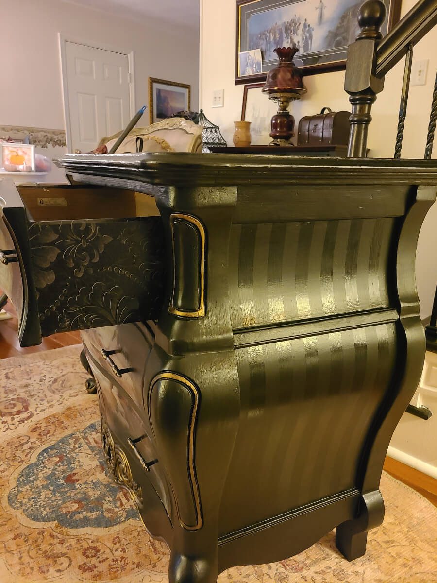 A close up of the drawer on an antique dresser