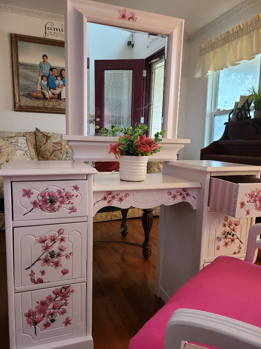 A white desk with pink flowers on it