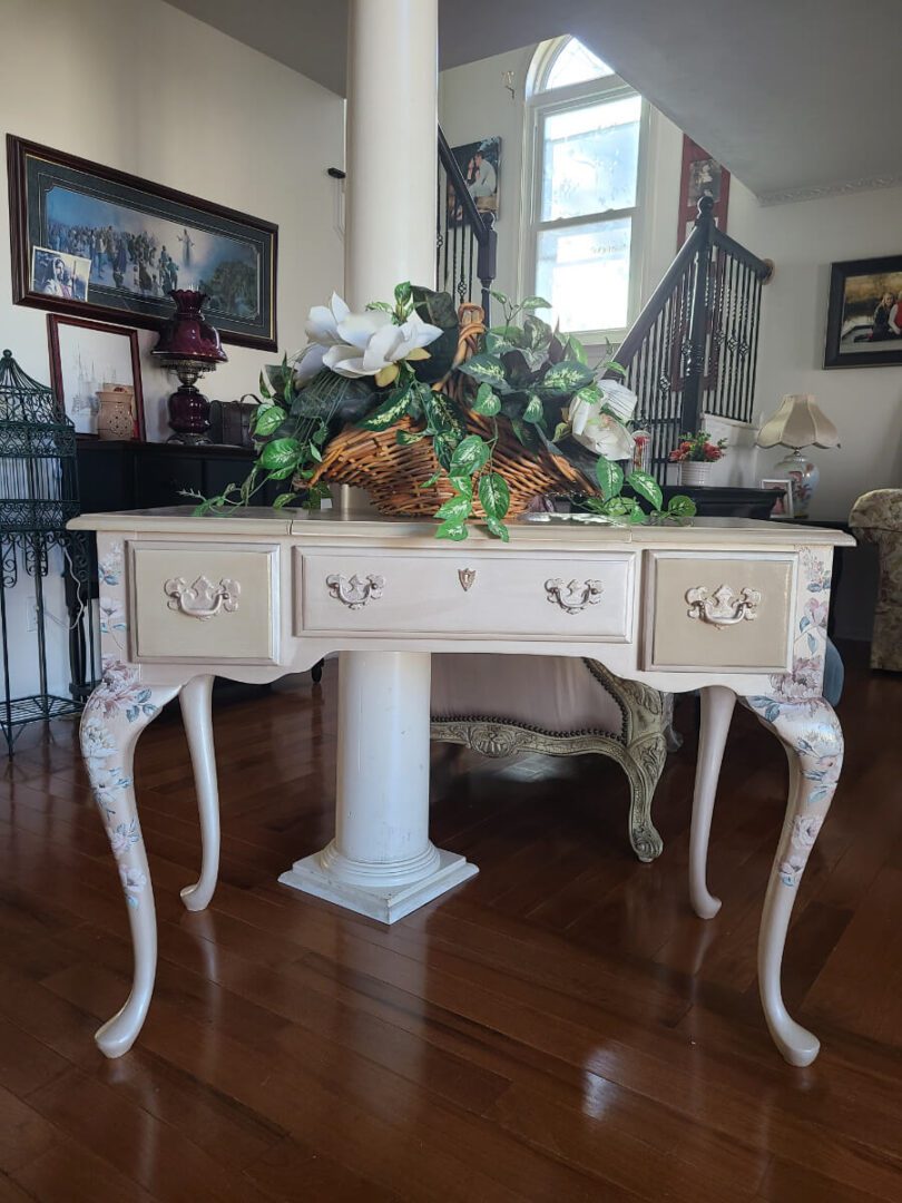 A table with three drawers and a pedestal.