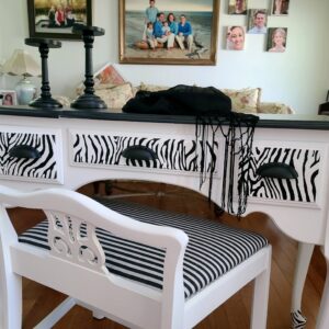 A desk with zebra print and black and white stripes.