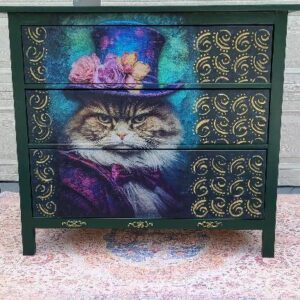 A dresser with a cat on it's face and top hat.
