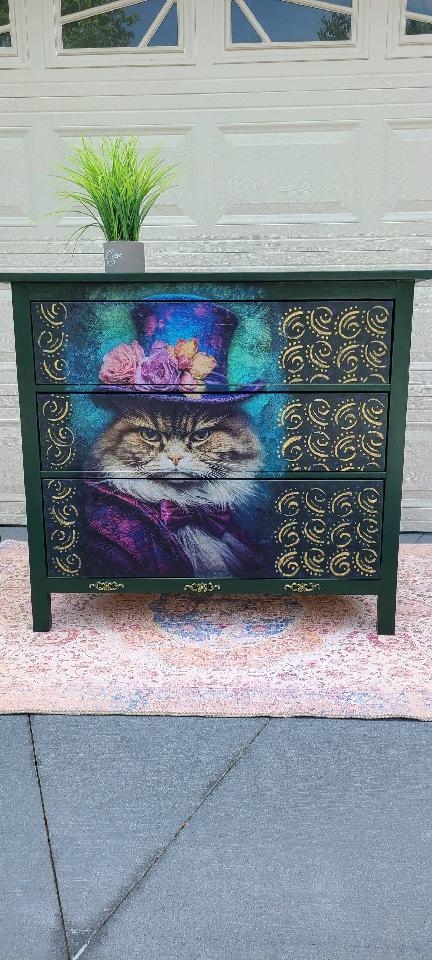 A dresser with a cat on it's face and top hat.