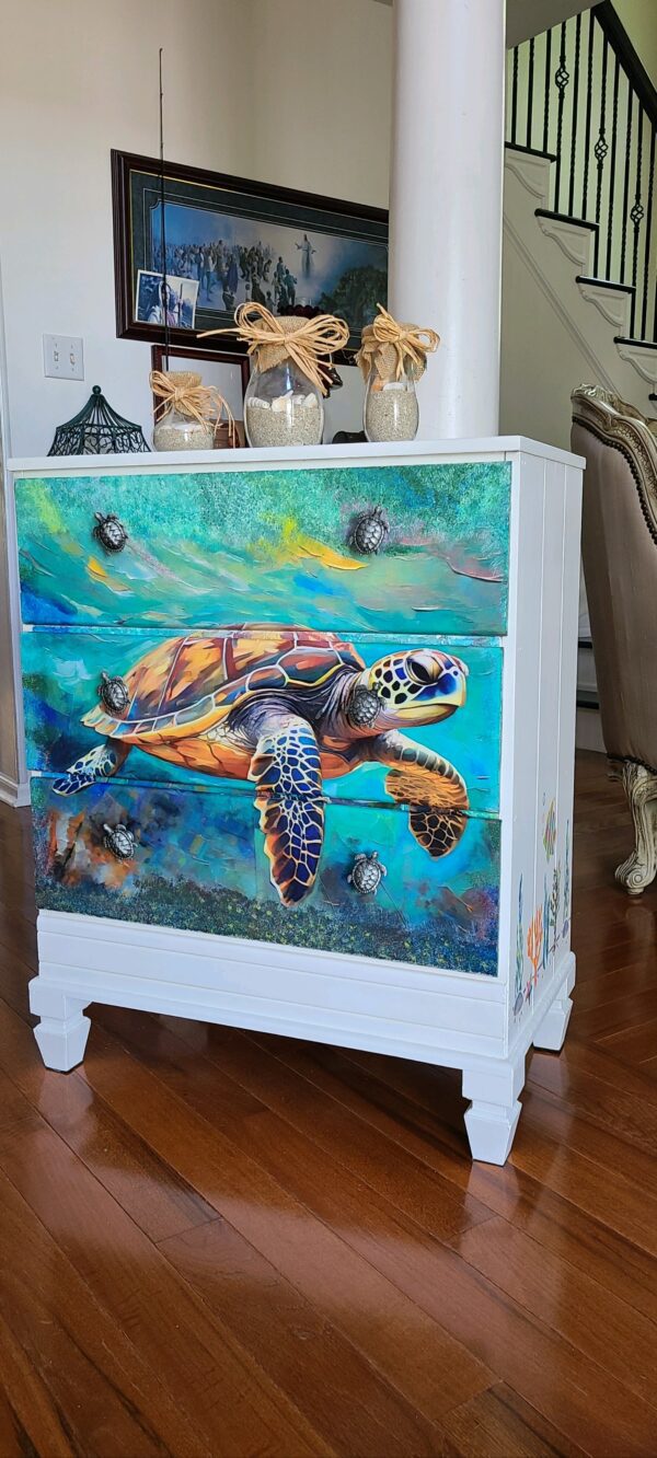 A turtle painted on the side of a dresser.