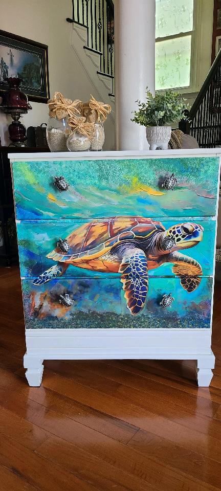 A painting of a turtle on the side of a dresser.