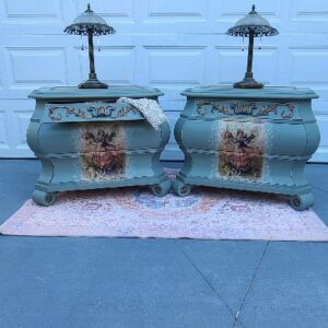 Two ornate end tables with lamps.